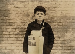 Tony Casale, 11-year-old Newsboy, has been selling for 4 years, sometimes until 10:00 p.m., Half-Length Portrait, Hartford, Connecticut, USA, March 1909