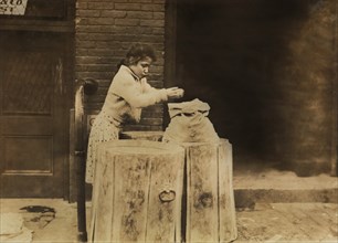 Young Girl Picking over Ash Barrels, Boston, Massachusetts, USA, Lewis Hine for National Child Labor Committee, October 1909