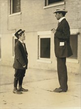 A.D.T. Boy, 13 years, Portrait Standing Facing Man, Burlington, Vermont, USA, Lewis Hine for National Child Labor Committee, September 1910