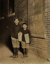 Isaac Solovitch, 12 years, David Solovitch, 7 years, Newsies, Portrait Standing at Night, Lawrence, Massachusetts, USA, Lewis Hine for National Child Labor Committee, November 1910