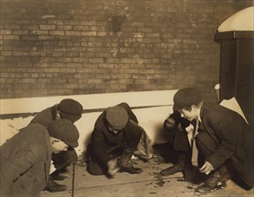 Four Young Boys Playing Game of Craps in Jail Alley at Night, Albany, New York, USA, Lewis Hine for National Child Labor Committee, February 1910