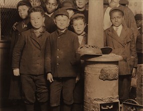 Group of Young Newsboys at 5:00 a.m. on Sunday Getting Ready to Sell Newspapers from McIntyre's Branch, Chestnut and 16th Streets, St. Louis, Missouri, USA, Lewis Hine for National Child Labor Committ...