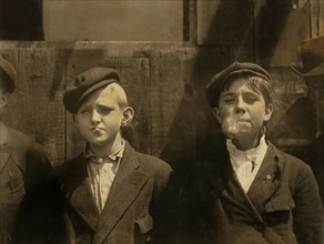 Two Young Newsboys Smoking, Half-Length Portrait, St. Louis, Missouri, USA, Lewis Hine for National Child Labor Committee, May 1910