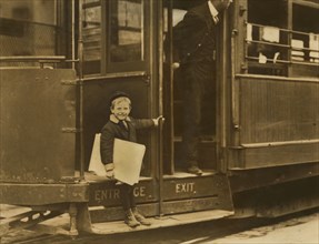 Francis Lane, 5-year-old Newsboy, Portrait Riding on Street Car, Grand Avenue, St. Louis, Missouri, USA, Lewis Hine for National Child Labor Committee, May 1910