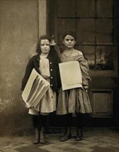 Two Young Girls Selling Newspapers, Full-Length Portrait, Wilmington, Delaware, USA, Lewis Hine for National Child Labor Committee, May 1910