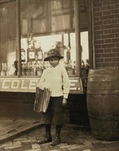 James Morgan, 9-year-old Newsboy, Selling Newspapers for 4 years, Works 6 hours per Day, Visits Saloons, Full-Length Portrait, Wilmington, Delaware, USA, Lewis Hine for National Child Labor Committee,...