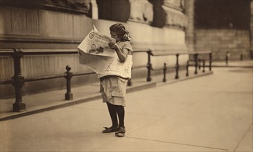 Young Newsgirl Reading Newspaper, Park Row, New York City, New York, USA, Lewis Hine for National Child Labor Committee, July 1910