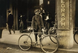 Postal Telegraph Messenger, Portrait Standing with Bicycle at Sidewalk, Birmingham, Alabama, USA, Lewis Hine for National Child Labor Committee, November 1910