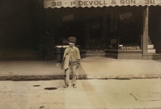 Fernace Silvia, 7 years, Newsie, Portrait Standing on Street, New Bedford, Massachusetts, USA, Lewis Hine for National Child Labor Committee, August 22, 1911