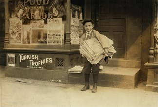 Hyman Lapcoff, 10-year old Newsie, Portrait Carrying Heavy Load of Newspapers, Washington DC, USA, Lewis Hine for National Child Labor Committee, April 1912