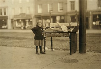 Young Girl, 6 years old, Selling Newspapers at Washington and Third Street, Full-Length Portrait, Hoboken, New Jersey, USA, Lewis Hine for National Child Labor Committee, December 1912