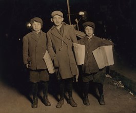 Three Young Boys Selling "Warheit" Jewish Newspapers at Midnight, Full-Length Portrait, Delancey Street, New York City, New York, USA, Lewis Hine for National Child Labor Committee, March 1913