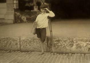 Albert Schafer, 8 years old, Newsboy, Amputee, Full-Length Portrait, Austin, Texas, USA, Lewis Hine for National Child Labor Committee, October 1913