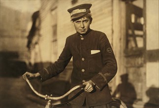 Western Union Messenger, 14 years old, Portrait with Bicycle, Houston, Texas, USA, Lewis Hine for National Child Labor Committee, October 1913