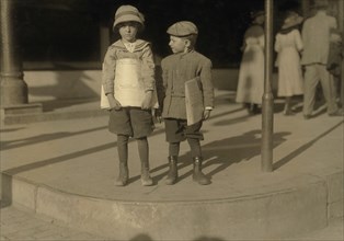 Odell McDuffy (left), Sam Stillman, Newsboys, 6 years old, Full-Length Portrait Selling Newspapers, Dallas, Texas, USA, Lewis Hine for National Child Labor Committee, October 1913