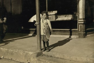 Tony, 6 years, Newsie, Portrait Standing on Sidewalk, Beaumont, Texas, USA, Lewis Hine for National Child Labor Committee, November 1913