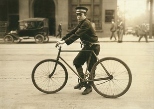 Western Union Telegraph Messenger Boy, Full-Length Portrait on Bicycle, Birmingham, Alabama, USA, Lewis Hine for National Child Labor Committee, October 1914