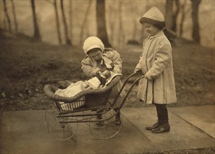 Two Young Girls Playing with Doll in Carriage, New York City, New York, USA, Lewis Hine for National Child Labor Committee, March 1912