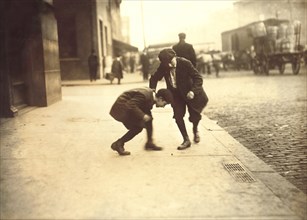 Two Young Boys Pitching Pennies on Sidewalk, Providence, Rhode Island, USA, Lewis Hine for National Child Labor Committee, November 1912