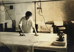 Sadie McGurin, 15 years old, Pressing Curtains, Boutwell, Fairclough & Gold, Boston, Massachusetts, USA, Lewis Hine for National Child Labor Committee, January 1917