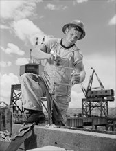 Carpenter Drilling Hole at Tennessee Valley Authority's new Douglas Dam, French Broad River, Sevier County, Tennessee, USA, Alfred T. Palmer for Office of War Information, June 1942