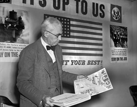 Elmer Davis, Director of Office of War Information, Examining Nazi and Japanese Propaganda Organs at Press Conference to show Material the Axis is Distributing in Neutral Countries, Office of War Info...