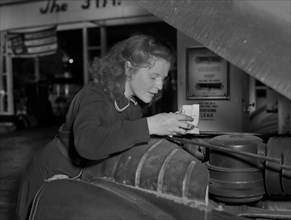 Virginia Excell, formerly a Butcher, now a Service Station Attendant as new Jobs have opened up for Women during WWII, Checking Car Engine, East Liverpool, Ohio, USA, Ann Rosener, Office of War Inform...