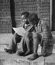 Two Young Boys Reading Instructions for Scrap Collection, Roanoke, Virginia, USA, Howard Liberman for Office of War Information, October 1942