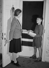 Captain Charles Wentworth, Junior Commando, Handing Mrs. John Farr a Leaflet Announcing Collection of Scrap Metal and Rubber during Scrap Salvage Campaign, Roanoke, Virginia, USA, Howard Liberman for ...