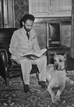 Haile Selassie (1892-1975), Emperor of Ethiopia, Portrait Reviewing Report alongside his Pet Dog, Bull, Upon his Return to Addis Ababa, Ethiopia after Allied Defeat of Italian Fascist Occupation Force...