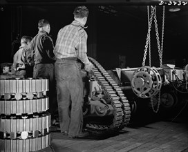 Group of Workers Mounting Tractor Belt on Chassis of the Army's Half-Track Scout Car at Factory Converted to War Production, White Motor Company, Cleveland, Ohio, USA, Alfred T. Palmer for Office of W...