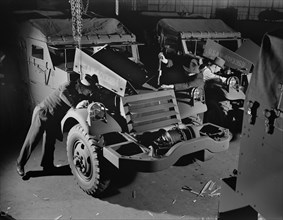Army's Half-Track Scout Cars Being Inspected before Delivery from Factory Converted to War Production, White Motor Company, Cleveland, Ohio, USA, Alfred T. Palmer for Office of War Information, Decemb...