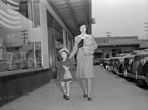 Mother and Daughter Walking Home with Bundles after Shopping While Helping to Conserve Tires on Car or a Merchant's Delivery Truck, as well, during War Effort, Ann Rosener, Office of War Information, ...