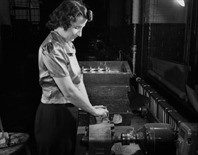 Rita Allen Sanding V-blocks to Remove Marks made by Milling Machines. This Razor Factory Converted many of its Machines to the Production of Tool Posts, which were Essential to War Production, Boston,...