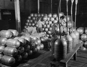 Three Workers Testing and Stacking Shatterproof Oxygen Cylinders for High Altitude Flying Manufactured at Factory Converted to War Production, Firestone Tire and Rubber Company, Akron, Ohio, USA, Alfr...
