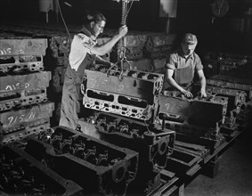 Two Workers Putting Engine Blocks for the Army's Half-Track Scout Car on Assembly Line at Factory Converted to War Production, White Motor Company, Cleveland, Ohio, USA, Alfred T. Palmer for Office of...