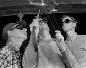 Instructor Training Two Young Men to Weld Aircraft at Vocational School as part of Program to Provide more Workers for War Production for Florida's Pooling Program, De Land, Florida, USA, Howard R. Ho...