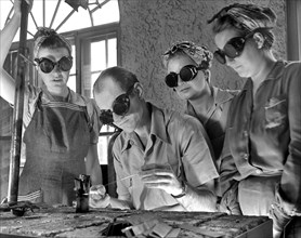 Instructor Training Three Women to Weld Aircraft at Vocational School as part of Program to Provide more Workers for War Production for Florida's Pooling Program, De Land, Florida, USA, Howard R. Holl...