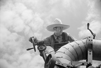 Clover Farmer on Seed Threshing Machine, St. Charles Parish, Louisiana, USA, Carl Mydans for U.S. Resettlement Administration, June 1936