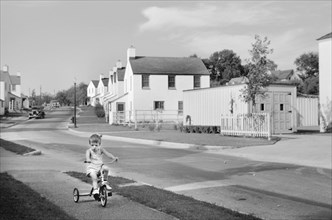 Young Boy Riding Tricycle, Greendale, Wisconsin, USA, a Greenbelt Community Constructed by U.S. Department of Agriculture as Part of President Franklin Roosevelt's New Deal, John Vachon for U.S. Reset...