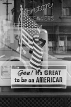 Man Standing near Store Window Sign, "Gee! It's Great to be an American", Covington, Kentucky, USA, John Vachon for Farm Security Administration, September 1939