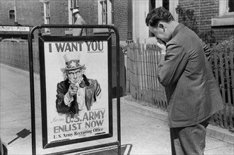 Man Looking at U.S. Army Recruitment Sign, Benton Harbor, Michigan, USA, John Vachon for Farm Security Administration July 1940