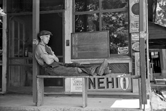Man Resting in front of General Store, Blankenship, Martin County, Indiana, USA, Arthur Rothstein for U.S. Resettlement Administration, May 1938