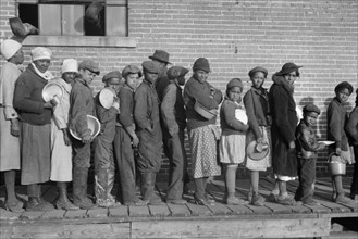 Lined up and Waiting for a Meal in camp for African-American Flood Refugees, Forrest City, Arkansas, USA, Edwin Locke for U.S. Resettlement Administration, February 1937