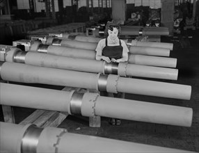 Mrs. Mary Betchner Inspecting 105mm Howitzer Artillery on Assembly Line, Chain Belt Company, Milwaukee, Wisconsin, USA, Howard R. Hollem for Office of War Information