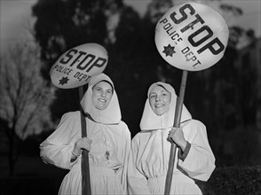Mrs. E.K. Sabel and Mrs. J.R. Harris, members of the Women's Safety Traffic Reserve, on duty Guarding School Crossing during School Hours, Oakland, California, USA, Ann Rosener for Office of War Infor...