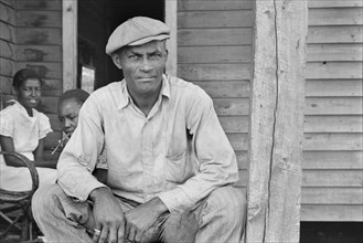 Sharecropper Sitting on Porch on Sunday, Little Rock, Arkansas, USA, Ben Shahn for U.S. Resettlement Administration, October 1935