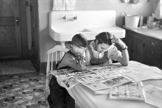 Children Reading Sunday Newspaper, Family of Tenant Farmer, Dickens, Iowa, USA, Russell Lee, U.S. Resettlement Administration, December 1936