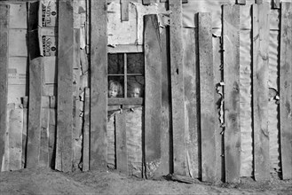 Detail Side of House, Two Children Looking out Window, Earl Pauley Farm, near Smithland, Iowa, USA, Russell Lee, U.S. Resettlement Administration, December 1936