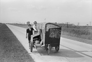 Traveling Evangelists Pushing Cart on Road between Lafayette and Scott, Louisiana, USA, Russell Lee, Farm Security Administration, October 1938
